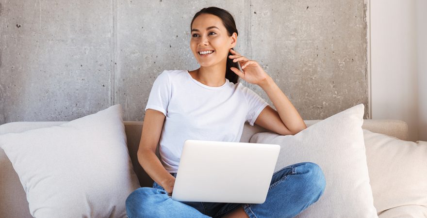 Pretty young asian woman using laptop computer Woman working at home